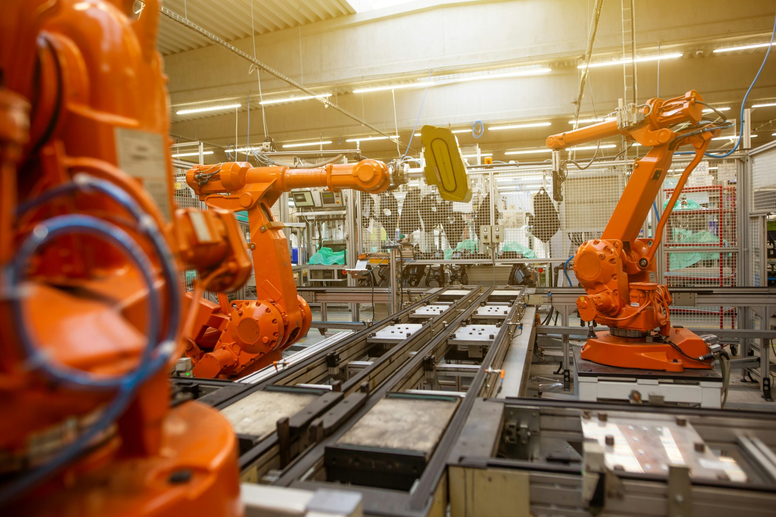 Photo by Simon Kadula on Unsplash AI-powered robots optimizing a lean manufacturing production line in a smart factory environment, symbolizing Industry 4.0.